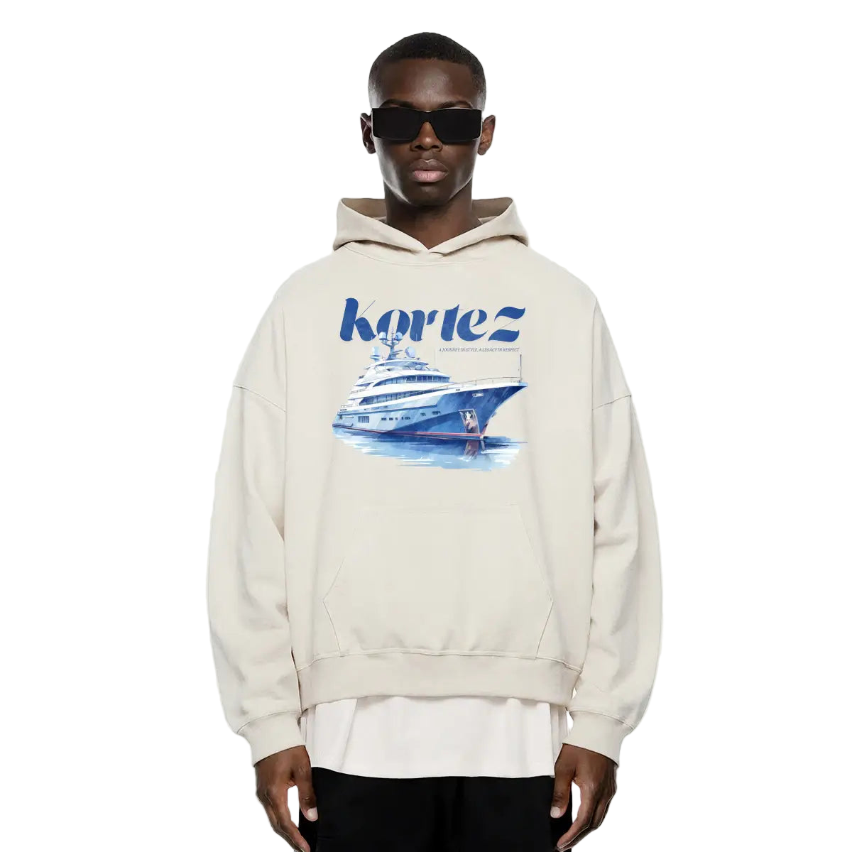 Person wearing a cream hoodie with a graphic design and 'Kortez' branding on a white background