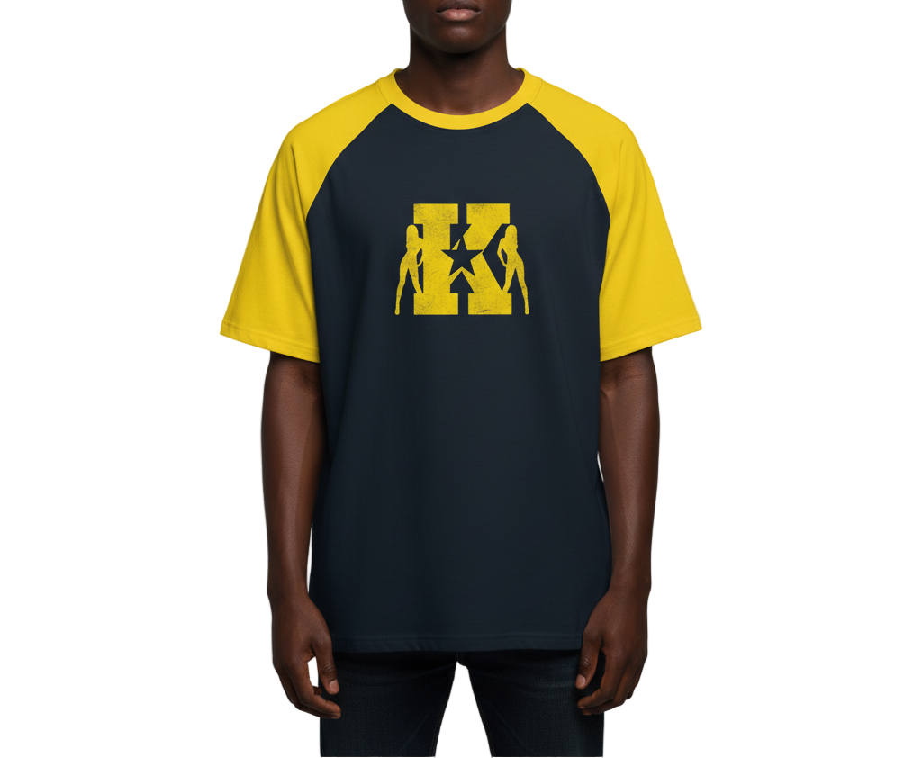 Person wearing a black and yellow baseball shirt with a graphic design on a gray background