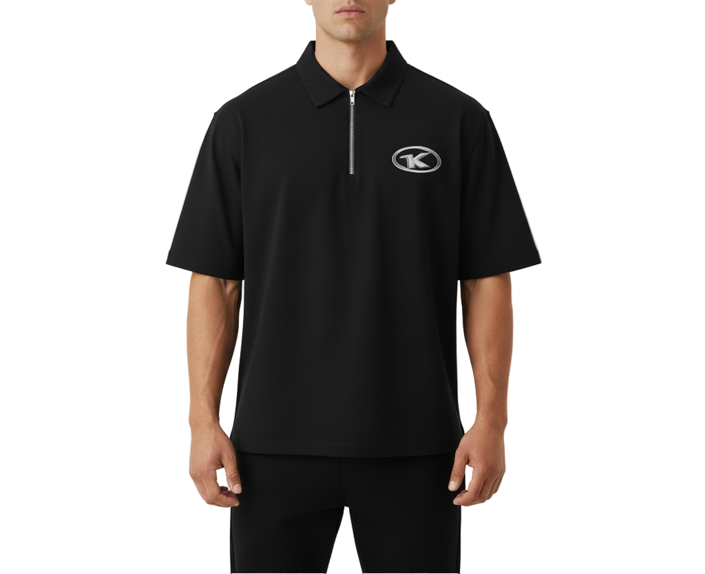 Man wearing a black polo shirt with a logo on a light gray background
