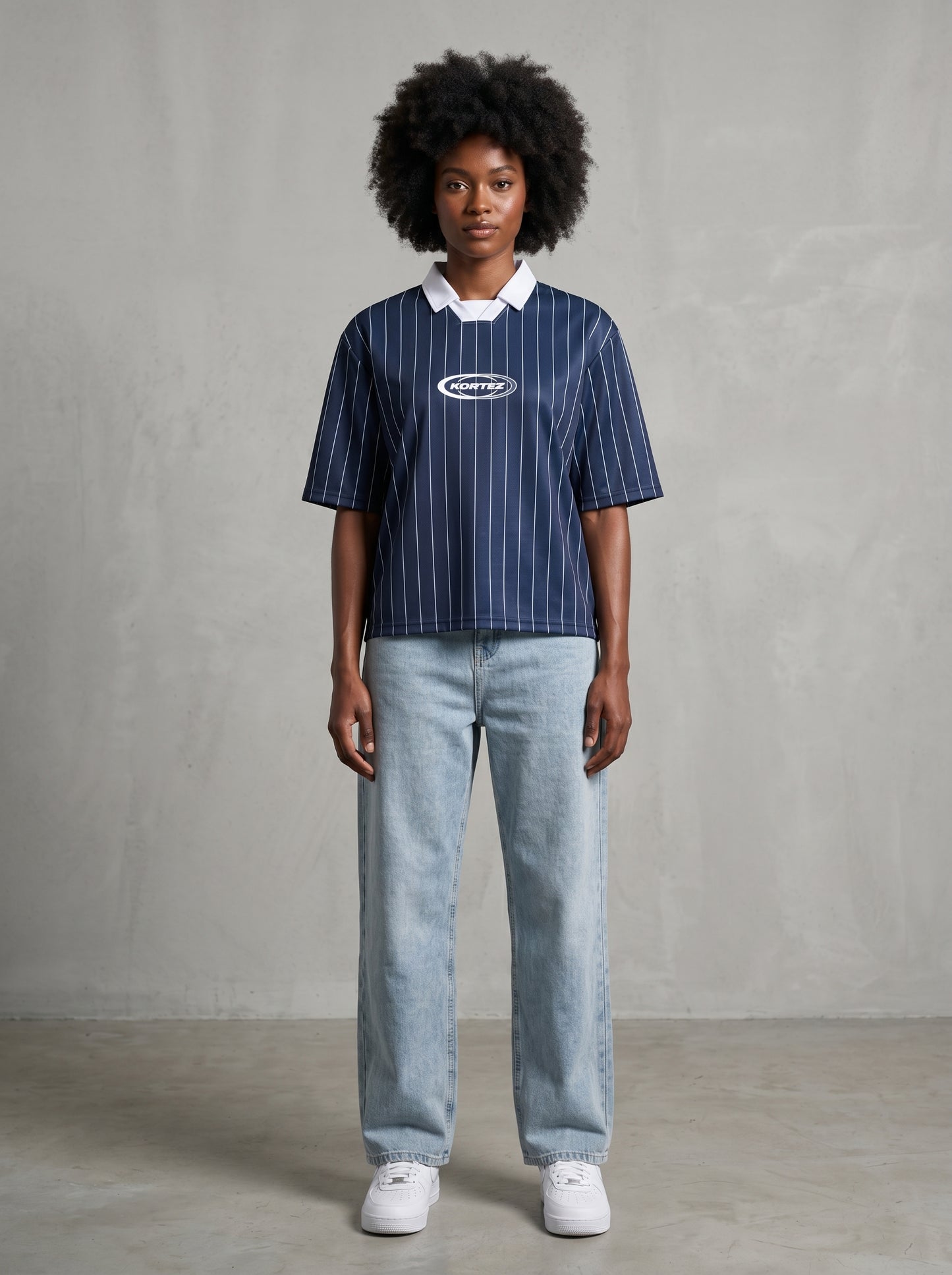 Navy blue pinstripe collared soccer jersey with white logo on model