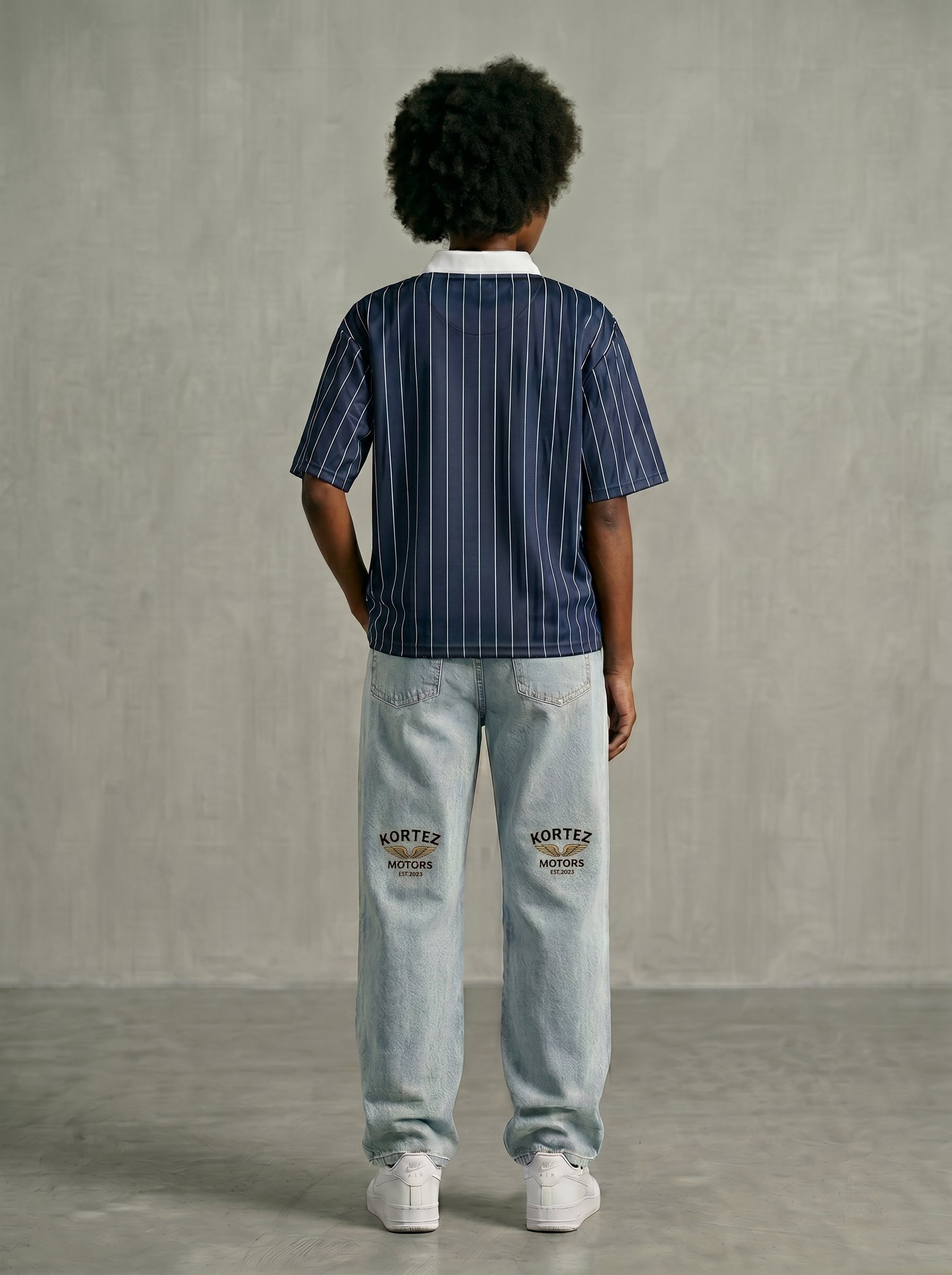 Navy blue pinstripe collared shirt back view with hands behind back