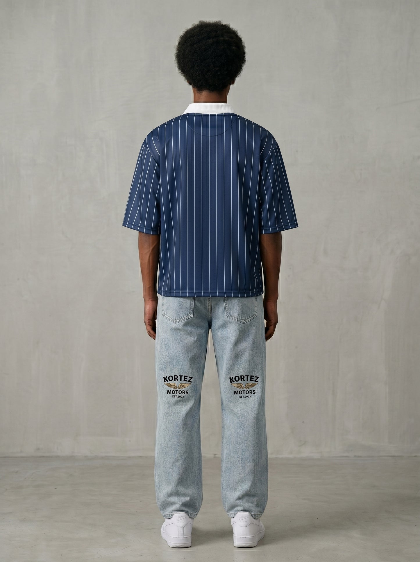 Back view of navy blue pinstripe collared soccer jersey on model