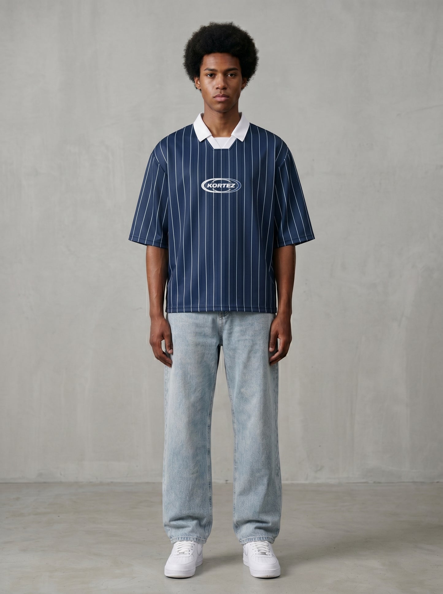 Navy blue pinstripe collared soccer jersey worn by man with afro